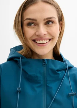 bonprix bonprix Chubasquero ligero con bolso estilo bandolera Petróleo azul Sale