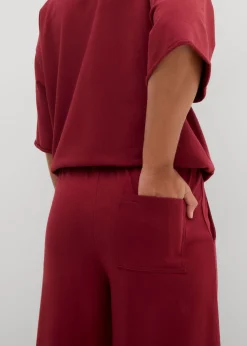 bonprix bonprix Pantalón de chándal de algodón orgánico con largo capri Ciruela Outlet